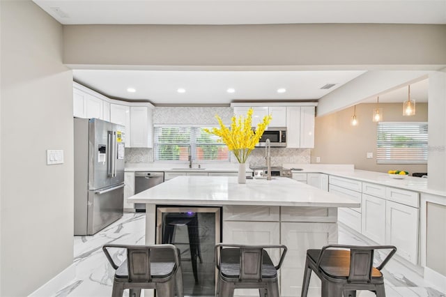 2042 Craft Ln, Sarasota, FL 34239 - kitchen featuring stainless steel appliances, a kitchen bar, marble finish floor, and tasteful backsplash