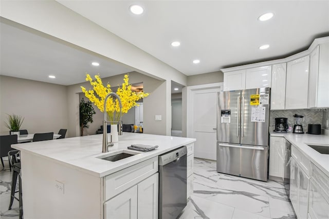 2042 Craft Ln, Sarasota, FL 34239 - kitchen featuring white cabinets, recessed lighting, appliances with stainless steel finishes, and marble finish floor