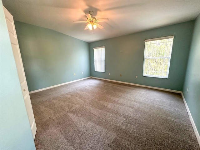 unfurnished room featuring ceiling fan, baseboards, and carpet