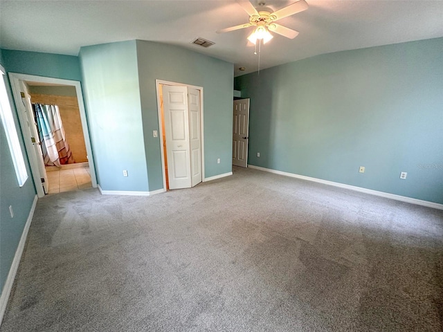unfurnished bedroom featuring visible vents, a ceiling fan, carpet, and baseboards
