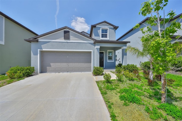 view of front of house with a garage, covered porch, stucco siding, and concrete driveway