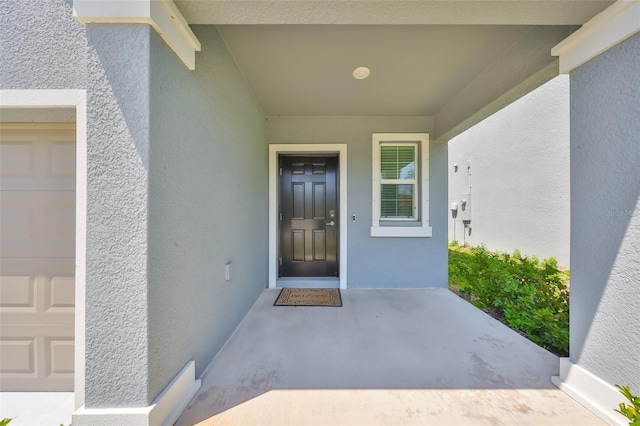 property entrance with stucco siding