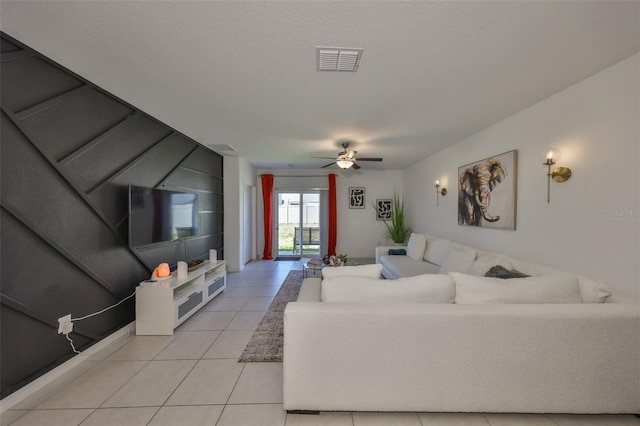 living room with ceiling fan, light tile patterned flooring, and visible vents