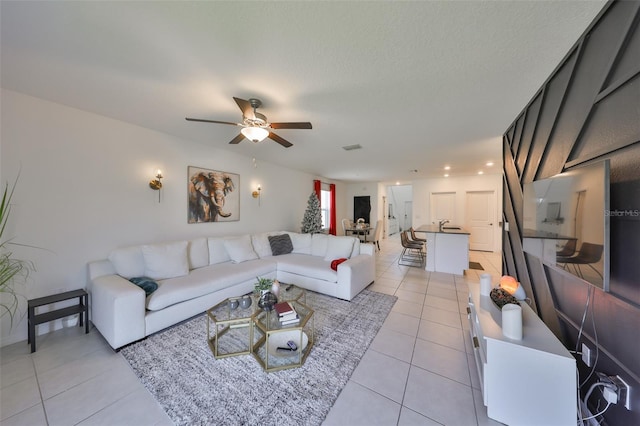 living area featuring light tile patterned floors, a ceiling fan, recessed lighting, and visible vents