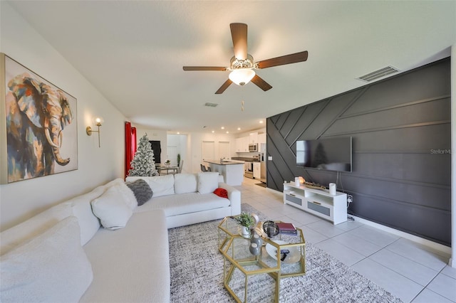living room with visible vents, a ceiling fan, and light tile patterned floors