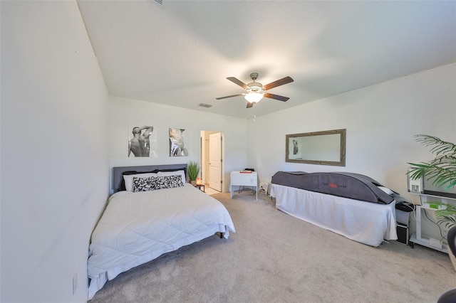 carpeted bedroom with visible vents and a ceiling fan