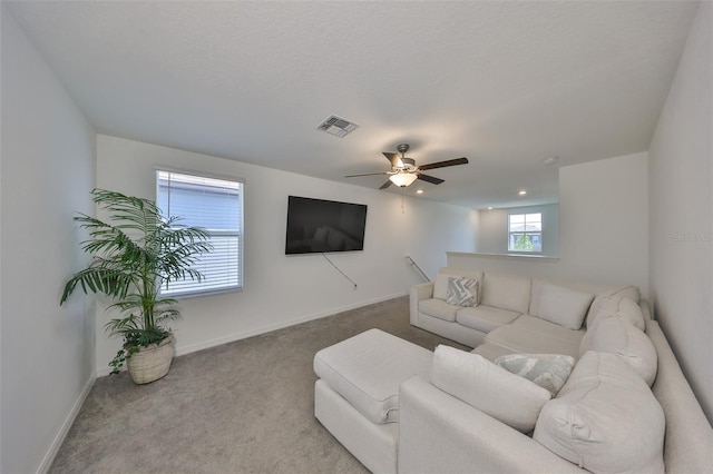 living room featuring baseboards, a ceiling fan, carpet flooring, and visible vents