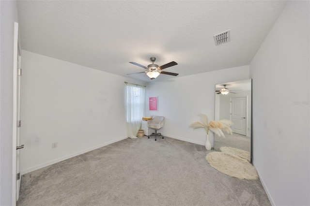 sitting room with baseboards, ceiling fan, carpet, and visible vents