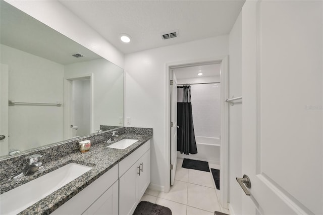 full bath featuring baseboards, tile patterned floors, visible vents, and a sink