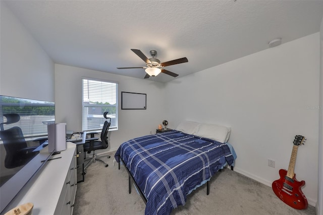 bedroom featuring baseboards, light carpet, and ceiling fan