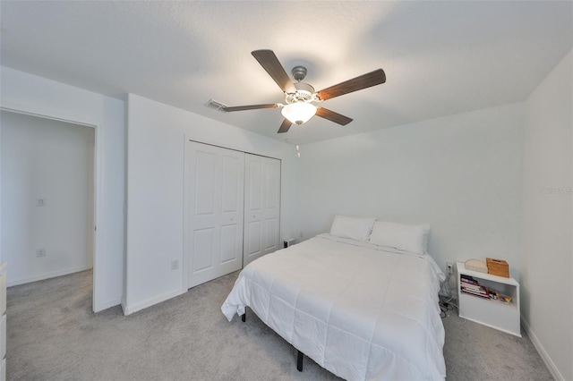 bedroom with visible vents, carpet flooring, baseboards, and a closet