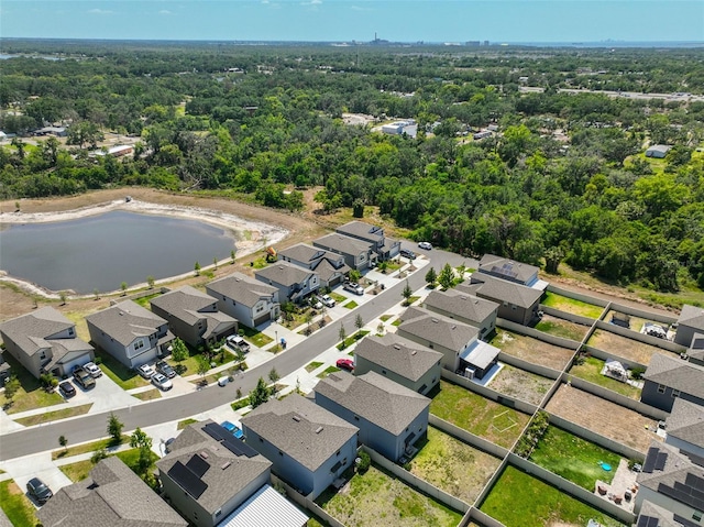 birds eye view of property featuring a wooded view, a water view, and a residential view