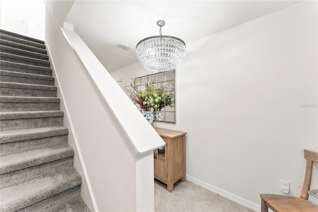35780 Sunflower Hill Dr, Zephyrhills, FL 33541 - staircase featuring baseboards, visible vents, an inviting chandelier, and tile patterned flooring