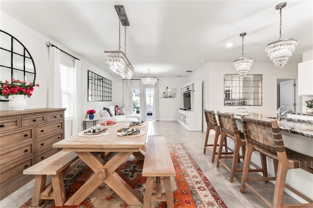 35780 Sunflower Hill Dr, Zephyrhills, FL 33541 - dining space with an inviting chandelier