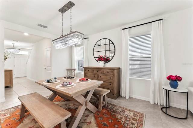 35780 Sunflower Hill Dr, Zephyrhills, FL 33541 - dining room featuring light tile patterned floors, a chandelier, and visible vents