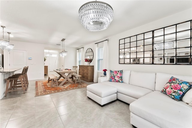 35780 Sunflower Hill Dr, Zephyrhills, FL 33541 - living area with an inviting chandelier, light tile patterned floors, and baseboards