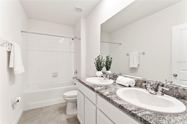 35780 Sunflower Hill Dr, Zephyrhills, FL 33541 - bathroom with double vanity, toilet, tile patterned floors, and a sink