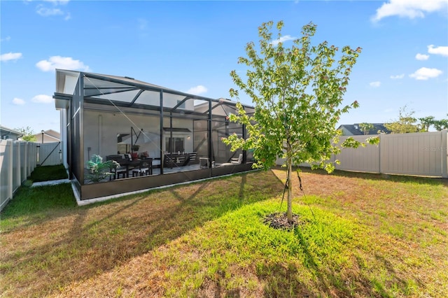 35780 Sunflower Hill Dr, Zephyrhills, FL 33541 - view of yard featuring a fenced backyard and glass enclosure