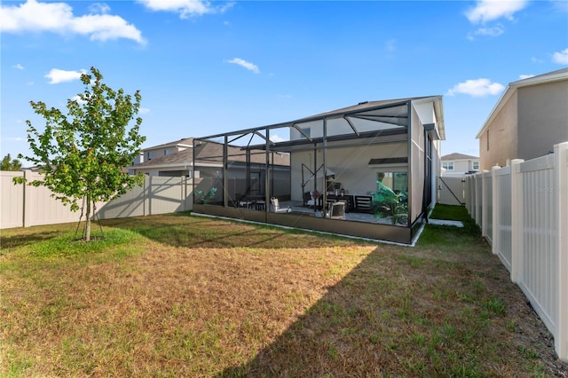 35780 Sunflower Hill Dr, Zephyrhills, FL 33541 - back of house with a yard, a lanai, and a fenced backyard