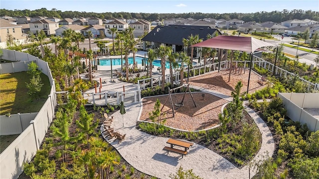 35780 Sunflower Hill Dr, Zephyrhills, FL 33541 - surrounding community featuring a residential view, a fenced backyard, and a pool