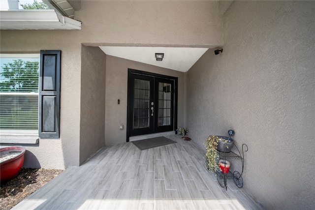 doorway to property with stucco siding and french doors