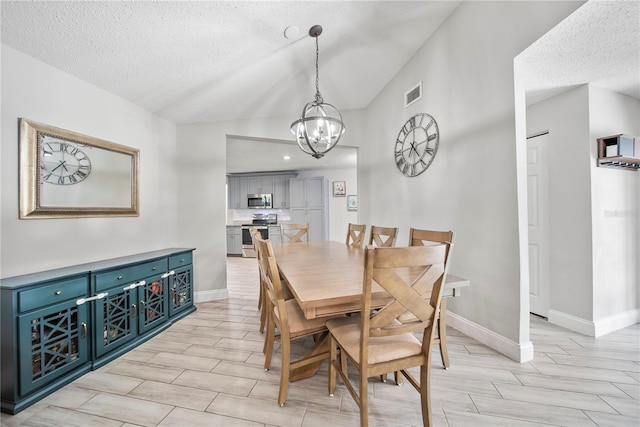 dining room with a notable chandelier, visible vents, a textured ceiling, and vaulted ceiling