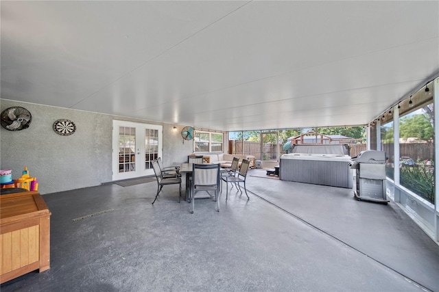 view of patio / terrace featuring outdoor dining area, french doors, a hot tub, grilling area, and a fenced backyard