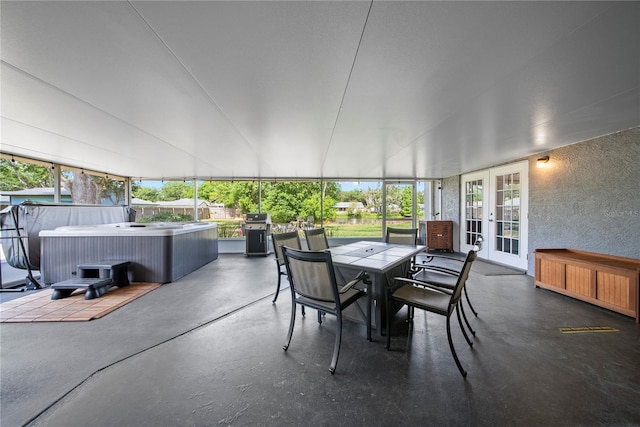 sunroom with french doors, outdoor dining space, and a jacuzzi