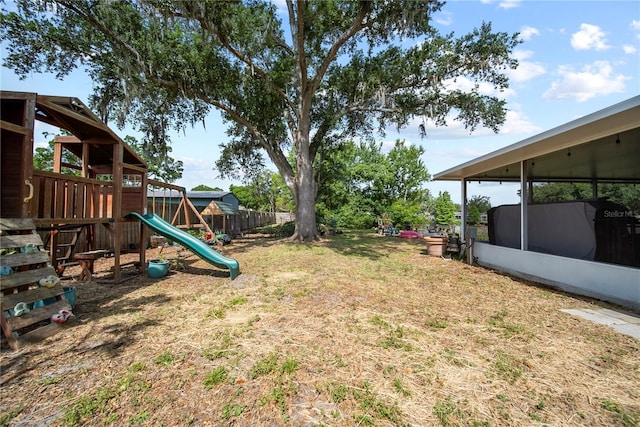 view of yard featuring a playground and fence