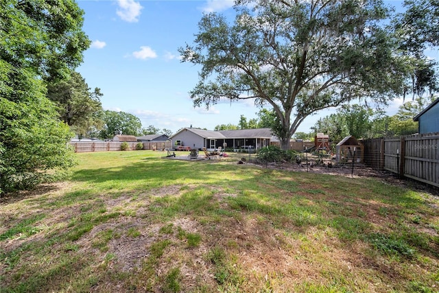 view of yard with a playground and a fenced backyard