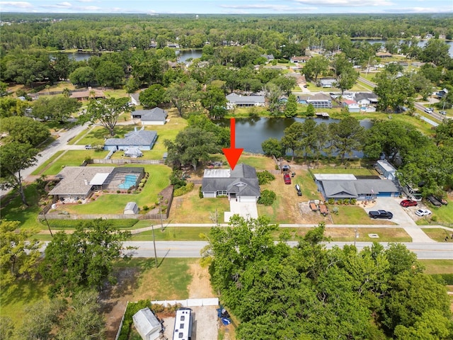 bird's eye view featuring a water view, a forest view, and a residential view