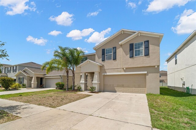 6708 Hazelnut Spice Dr, Ruskin, FL 33573 - view of front of property featuring a garage, stucco siding, a front yard, and concrete driveway