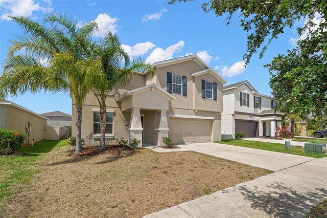 6708 Hazelnut Spice Dr, Ruskin, FL 33573 - view of front of home featuring a garage, a front lawn, stucco siding, concrete driveway, and a residential view