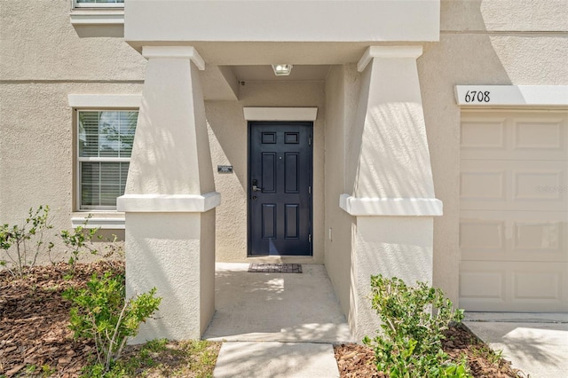 6708 Hazelnut Spice Dr, Ruskin, FL 33573 - doorway to property featuring stucco siding