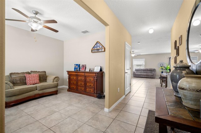 6708 Hazelnut Spice Dr, Ruskin, FL 33573 - living area featuring light tile patterned flooring, ceiling fan, and visible vents