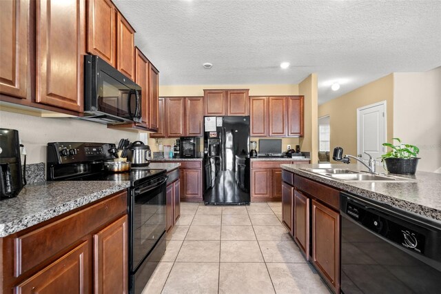 6708 Hazelnut Spice Dr, Ruskin, FL 33573 - kitchen featuring a sink, a textured ceiling, light tile patterned flooring, and black appliances