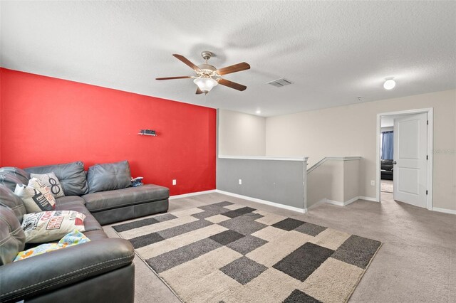 6708 Hazelnut Spice Dr, Ruskin, FL 33573 - living area featuring visible vents, carpet flooring, baseboards, a textured ceiling, and a ceiling fan