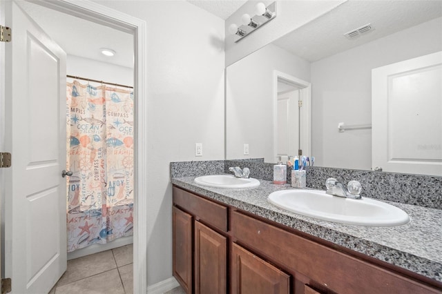 6708 Hazelnut Spice Dr, Ruskin, FL 33573 - bathroom with double vanity, a sink, tile patterned floors, and visible vents