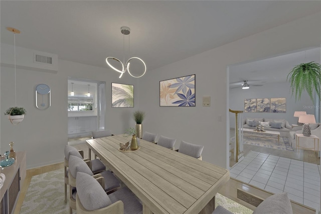 dining room with visible vents and ceiling fan with notable chandelier