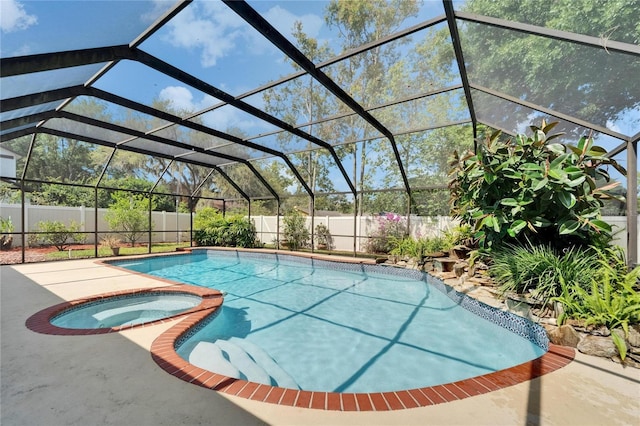 view of swimming pool featuring a fenced backyard, a fenced in pool, an in ground hot tub, a patio area, and glass enclosure