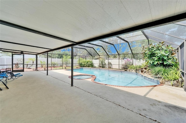 view of swimming pool featuring a fenced backyard, a lanai, a pool with connected hot tub, and a patio area