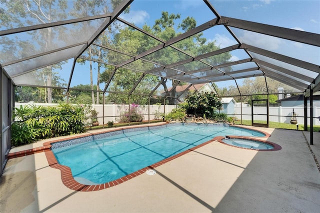 view of pool with a fenced backyard, a lanai, a pool with connected hot tub, and a patio area