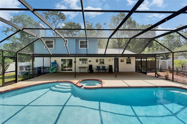 view of swimming pool featuring fence, a lanai, and a patio area