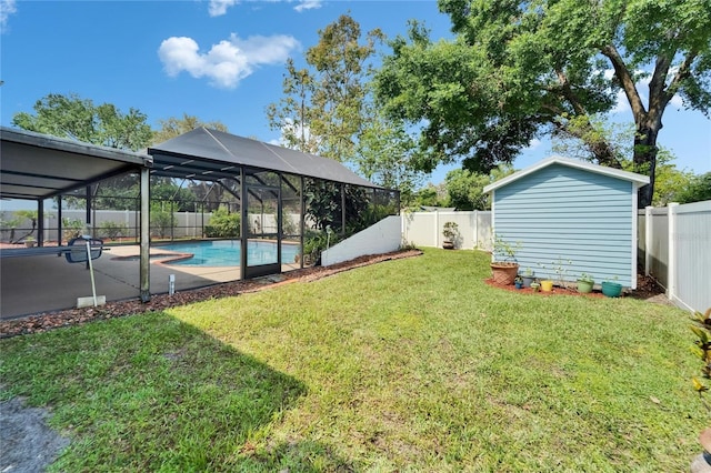 view of yard featuring a fenced backyard, a fenced in pool, an outbuilding, and glass enclosure