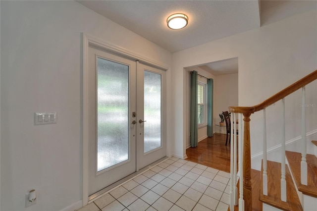 9410 Alanbrooke St, Temple Terrace, FL 33637 - entryway with french doors, stairs, and light tile patterned flooring