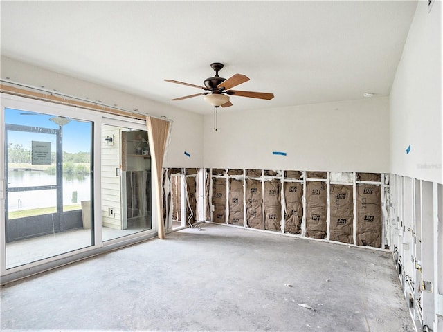 empty room with a ceiling fan and a water view