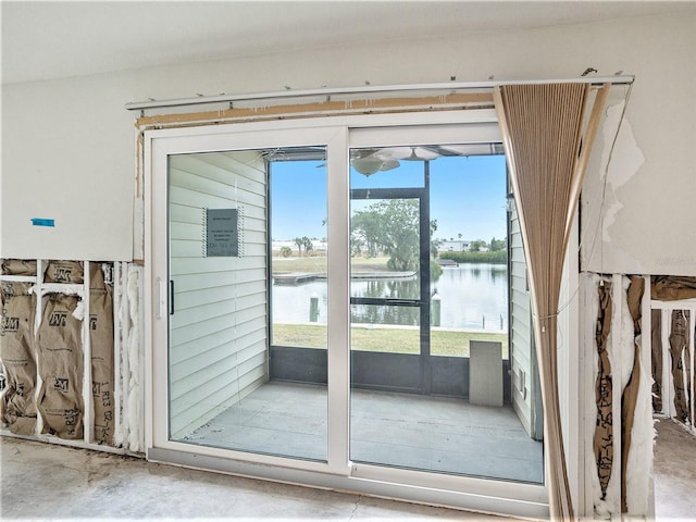 doorway to outside with concrete floors and a water view
