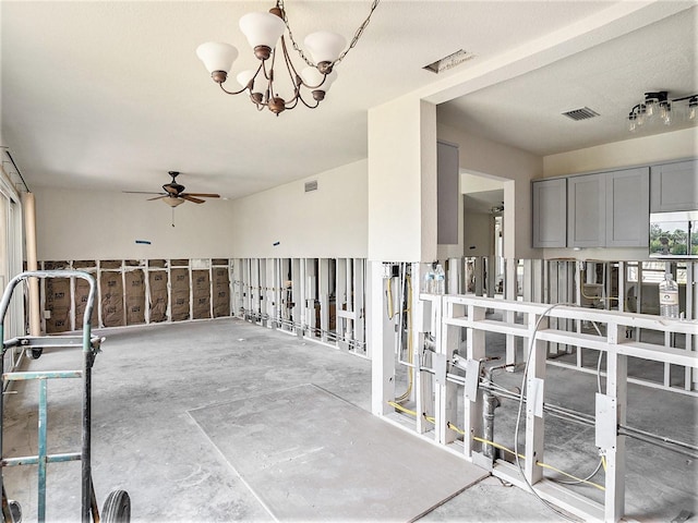 interior space with visible vents and ceiling fan with notable chandelier