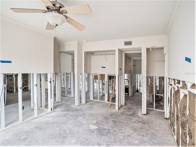 unfurnished bedroom featuring ornamental molding, two closets, ceiling fan, and visible vents