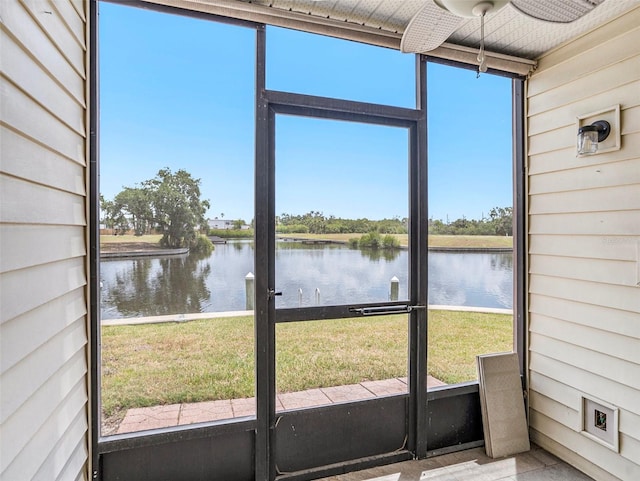 unfurnished sunroom featuring a water view